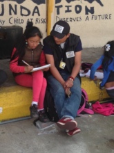 Street outreach worker helping with homework