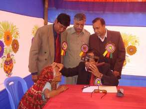 A doctor screeninng Cataract Patients in a Camp