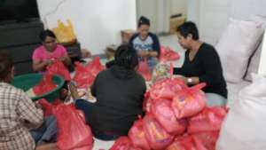 Preparing food packages with local volunteers