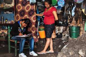 Areceli interviews a household cook at home.