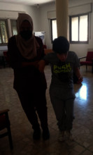 Mother helping her blind daughter