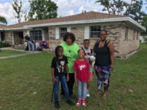 Edna and family in front of repaired home