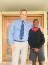 Dominic and his new headmaster, Mr Van Rensberg