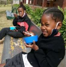 Younger learners enjoying their lunch.