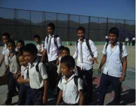 Older brothers walking young students to class