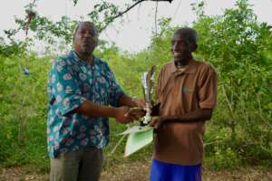 Mzee Mwaringa reciving the Winners Trophy