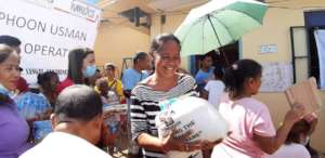 Local residents receiving supplies one by one