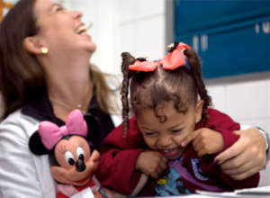 Preschool student laughing with the pediatrician