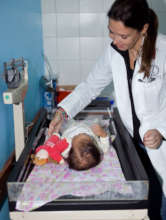 Pediatrician checks baby's weight