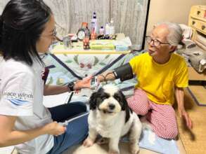 Peace Winds staff and resident during house call