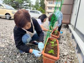 Setting up planters outside temporary housing
