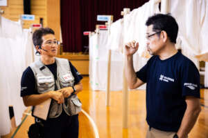 Dr. Inaba talks to colleague at evacuation center