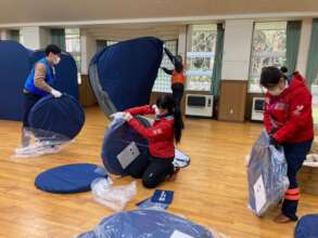 Setting up tents at evacuation center