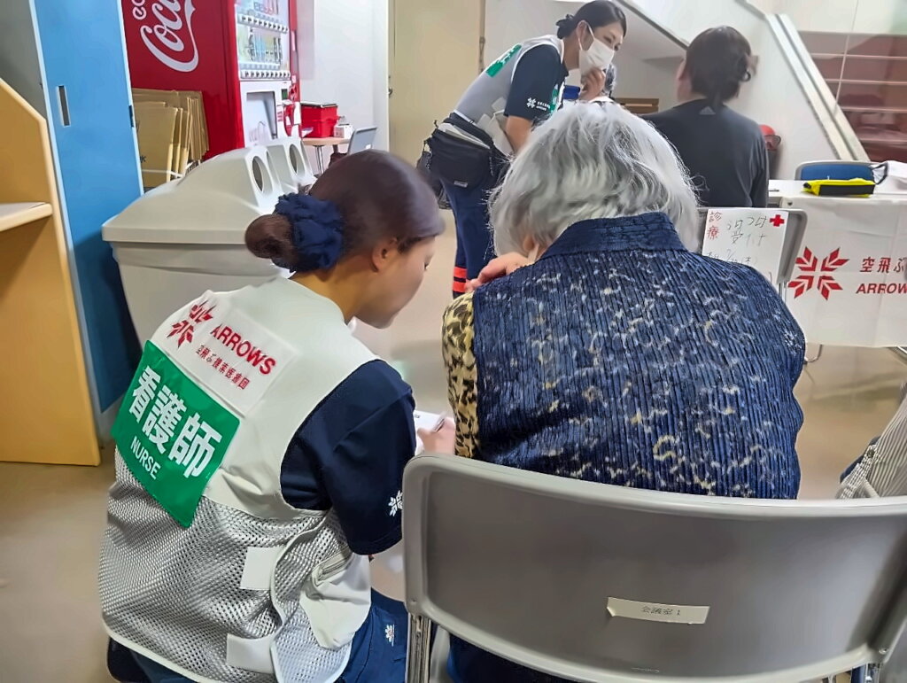 Nurses with survivors at evacuation center
