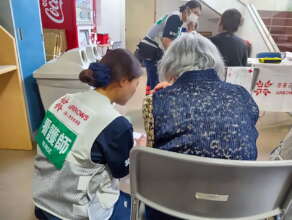 Nurses with survivors at evacuation center