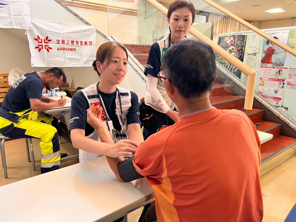 Dr. Morita examines patient at evacuation center