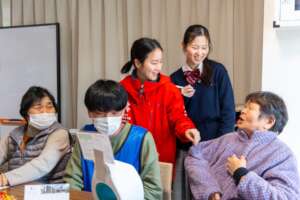 Nanami speaks with Suzu residents at a tea hour