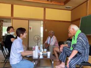 A Peace Winds volunteer talks with survivors