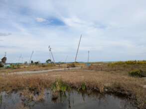 Empty lots and bent utility poles in Suzu