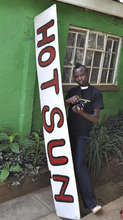 Ronald Omondi with camera & Hot Sun sign