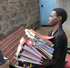 Kibera Film School trainee moving files