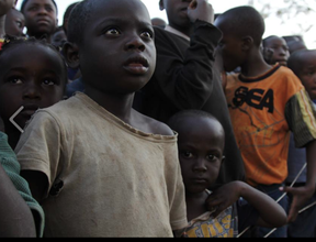 Children watching Slum Film Festival entertainment
