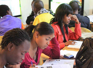 Young East African working on scripts