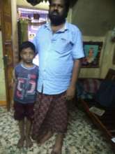 Gokul with his father with a new device