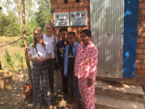 Family proudly displaying new brick latrine
