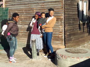 Khanyisa Reading parter at home with family