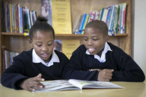 Two children reading a book