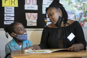 Youth reading one-on-one with a child