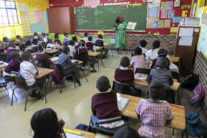 Youth reading a story to a grade 2 classroom