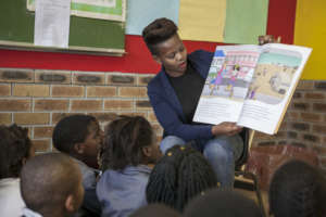 A Khanyisa Reading Partner reading a story