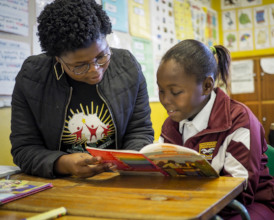 A Reading Partner reading with a child (2019)