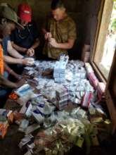 Volunteers and H.O.P.E. staff sort medication