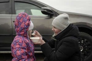 A mother feeding her daughter at the Medyka border