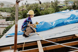 A volunteer working on a roof in Puerto Rico