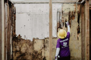 A volunteer assesses the damage