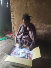 Beneficiary receiving nutritious feeds(RUTF)