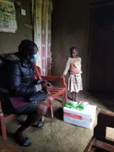 Beneficiary receiving nutritious feeds(RUTF)