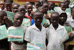 Smiling children with scholastic materials