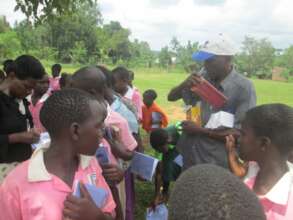 Beneficiaries receiving scholastic materials