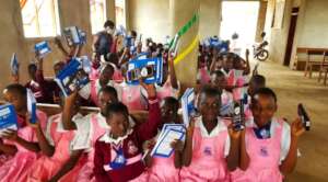 Smiling children with scholastic materials
