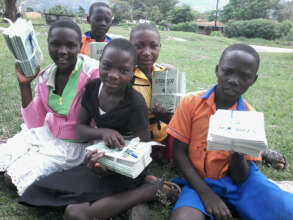 Smiling children with scholastic materials