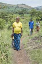 Ugandan mother walking to the health center