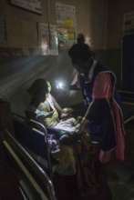 Mother, baby and midwife in the dark