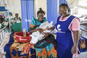 Mother and newborn with her midwife