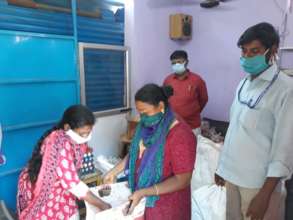 Viji (in pink) distributing relief packages