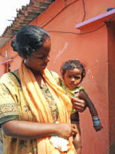 A mother and her daughter outside their home